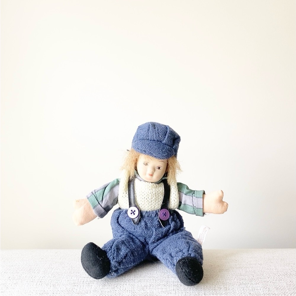 Plush Doll with Blue Overalls and Purple Buttons